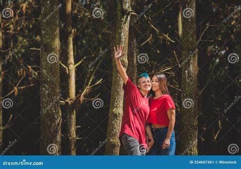 Happy Hispanic Lesbian Couple Hugging In A Forest Stock Image Image