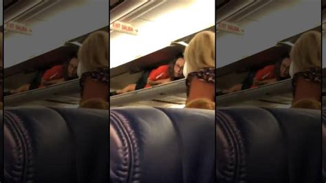 Southwest Airlines Flight Attendant Inside Overhead Compartment