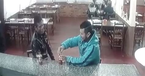 Shocking Moment Hitman Shoots Victim Dead From Close Range As He Enjoys A Beer With Friend