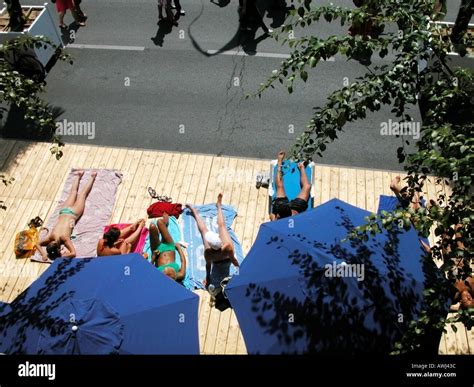 France Paris Plage People Sunbathing On Sun Deck By The Road Stock