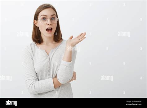 waist up shot of talkative entertained and amused good looking smart girl in glasses and blouse