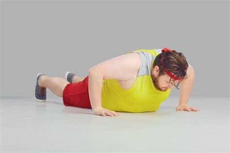 Fat Funny Guy With A Beard Doing Push Up Goes For Sports Stock Image