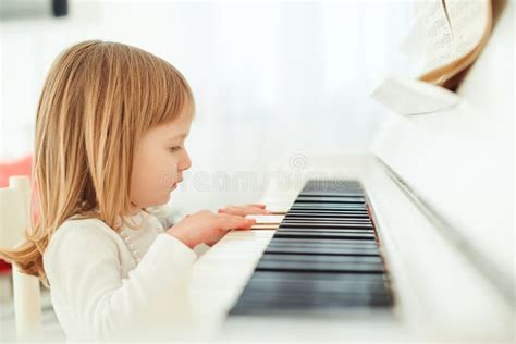 Cute Little Girl Playing Piano In Light Room Stock Image Image Of