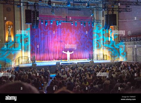 An Excited Audience Wait For A Show To Start In The Newly Opened