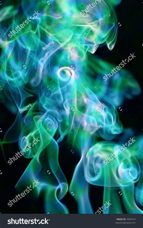 Bright Teal Green And Blue Smoke Background On Black Stock Photo