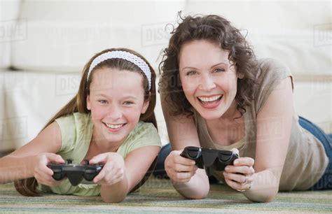Mother And Daughter Playing Video Games Stock Photo Dissolve
