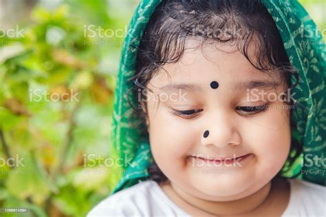 Cute Indian Baby Girl With Traditional Indian Dress With Bindi On Her