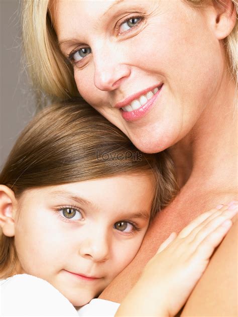 Mom Hugging Her Daughter Looking At Camera Picture And Hd Photos Free Download On Lovepik