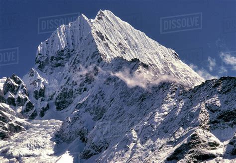 The Jagged Peaks Of Tamserku At 21680 Ft Jut Into The Blue Skies Of