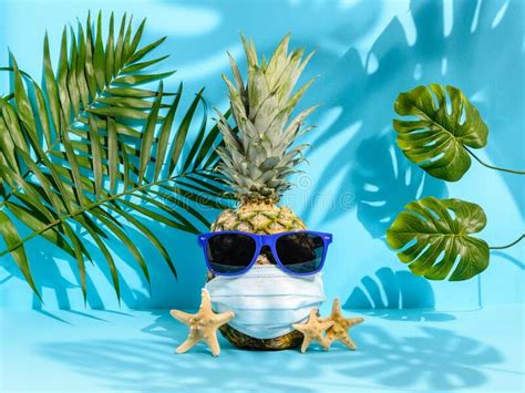 Summer 2020 Pineapple In Sunglasses And Medical Mask Among Palm Leaves