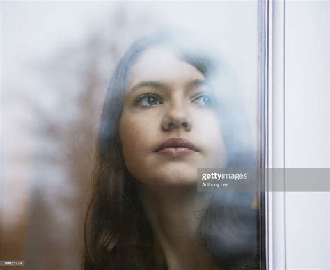 Girl Looking Out Window High Res Stock Photo Getty Images