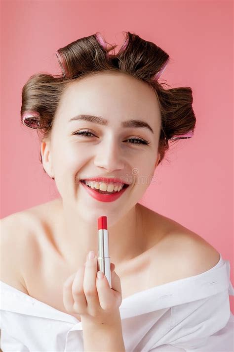 Closeup Portrait Of Beautiful Girl Putting On Red Lipstick Stock Photo