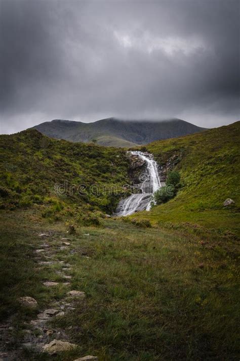 Nature Landscape With A Waterfall Under A Cloudy Sky In The Isle Of