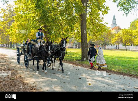 Horse Drawn Carriage And Walking 18th Century Interpreters In Colonial