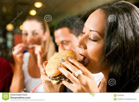 Friends Eating Fast Food In A Restaurant Stock Photo Image Of