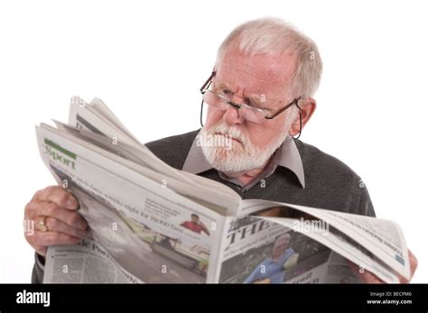 Old Man Sitting Down Reading A Newspaper Stock Photo