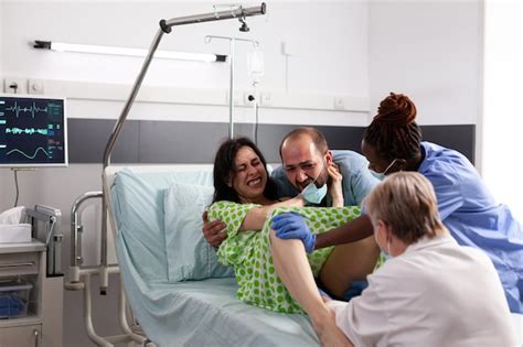 Premium Photo Young Woman Giving Birth To Child In Hospital Ward