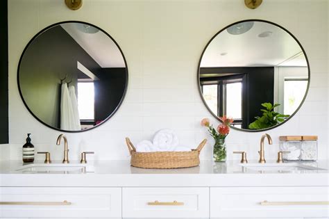Ideal above a console table in the hallway, above a beautiful fireplace, in the bedroom or in the bathroom. Twin Round Bathroom Mirrors and White Vanity | HGTV