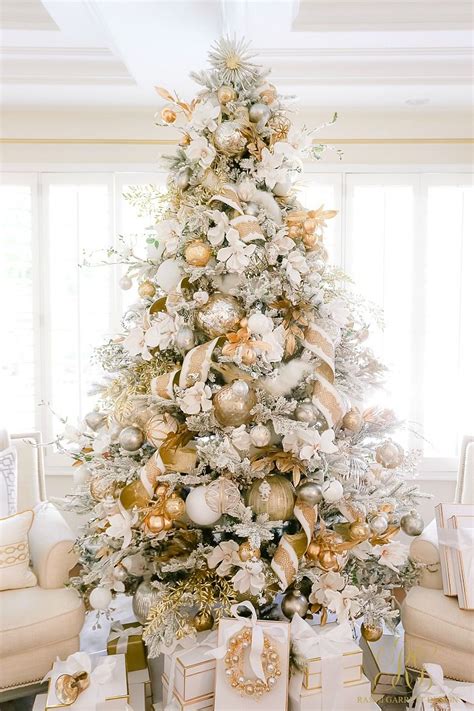 A White Christmas Tree With Gold And Silver Ornaments