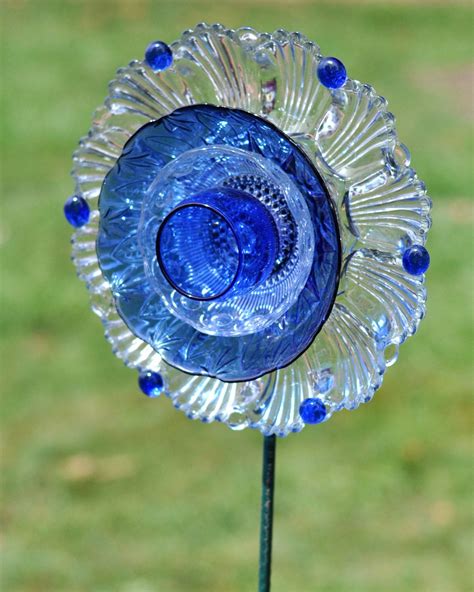 Clear glass by itself doesn't show up very well in the garden. Repurposed Glass Garden Flower Wall or Garden Art Made of