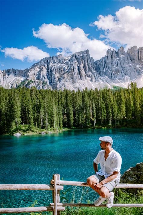 Men Visit Hte Bleu Lake In The Dolomites Italy Carezza Lake Lago Di