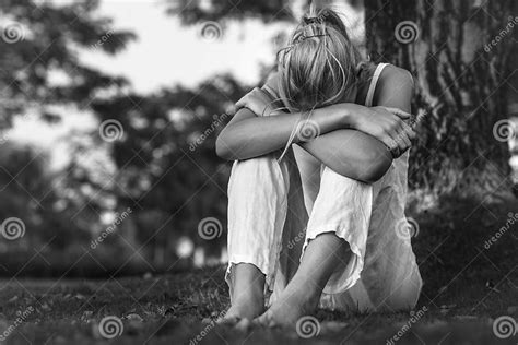 A Depressed Woman Sitting Alone Outside Crying Pain And Sorrow Stock