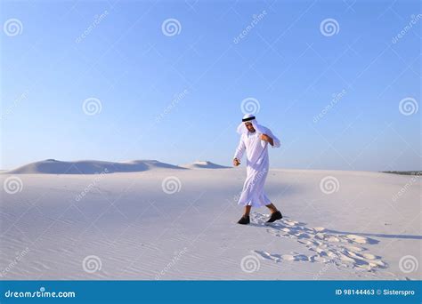 Happy Arab Man Walks In Middle Of White Desert And Enjoys Life O Stock