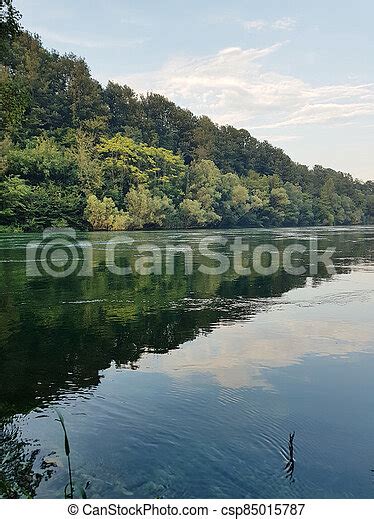 Clear Crystal Clear River Water With A Wooded Shore Landscape From