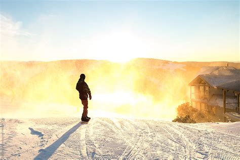 A Snowboard At Sunrise Looking Down The Hill Into The Morning Light