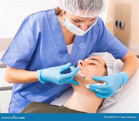 Beautician Injecting Facial Filler To Male Client Stock Photo Image