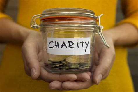 Woman Collecting Money For Charity And Holds Jar With Coins Stock