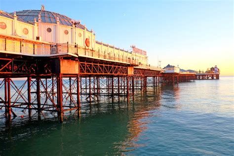 Brighton Pier Jutting Out Over Sea At Sunset Stock Image Image Of