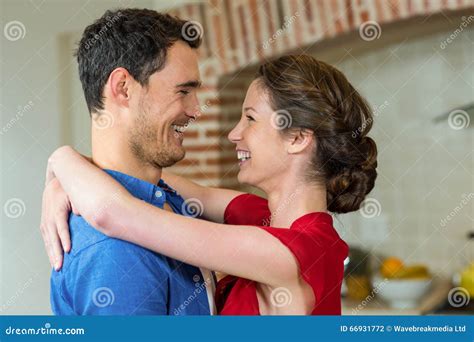 Romantic Couple Standing Face To Face And Embracing Each Other Stock