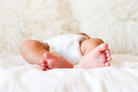 Free Stock Photo Of Sleeping Baby Feet On White Bedding