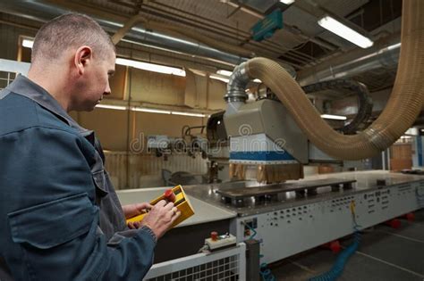 Concentrated Male Person Looking At Woodworking Machinery Stock Photo