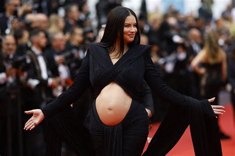 pregnant adriana lima showcases growing bump with sleek cut out dress at cannes film festival