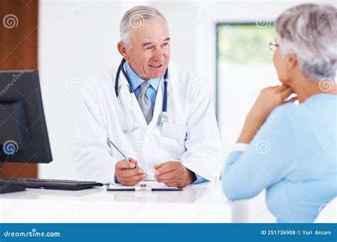Doctor Discussing Medical Report With Female Patient Mature Doctor Discussing Medical Report