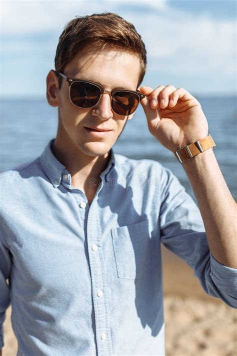 Beautiful Stylish Guy With Glasses Posing On The Beach Hipster Posing In Stylish Clothes For