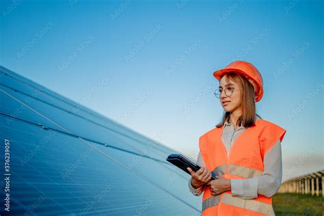 Inspector Engineer Woman Holding Digital Tablet Working In Solar Panels