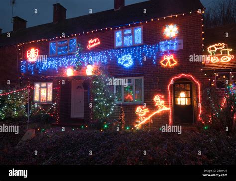 Exterior Of A House Lit Up With Christmas Lights At Dusk Home Property