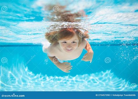 Kid Boy Swimming Underwater On The Beach On Sea In Summer Blue Ocean