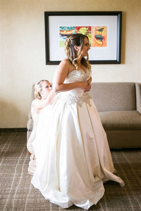 Sister Helps Bride With Dress
