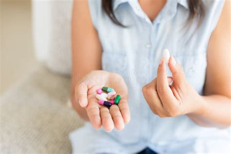 Woman Hand With Pills Medicine Tablets And Capsule In Her Hands Stock