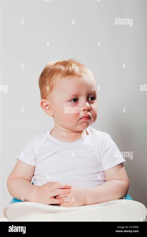 Baby Boy Sitting In High Chair Stock Photo Alamy