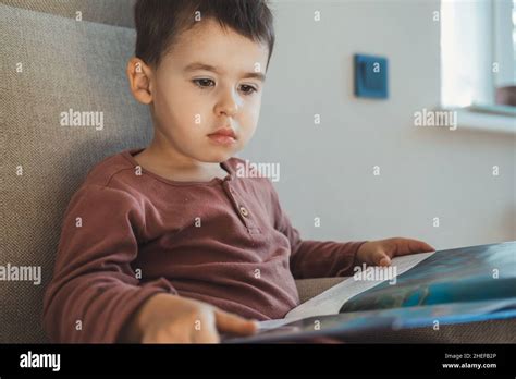 Caucasian Little Boy Reading Book At Home Fairy Tale Story Stock Photo
