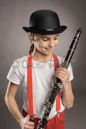 Little Girl Playing Clarinet On A Gray Background Stock Photo 1410289