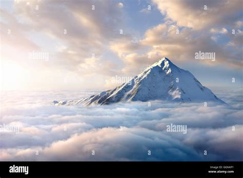 Snow Covered Mountaintop Above Clouds Stock Photo Alamy