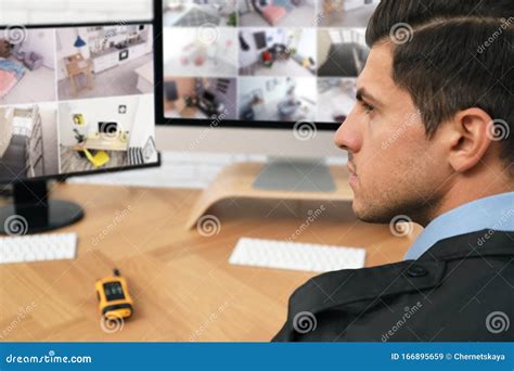 Male Security Guard Monitoring Cameras At Workplace Stock Image Image