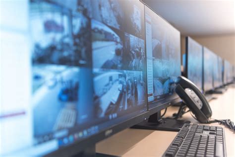 Security Guard Monitoring Modern Cctv Cameras In Surveillance Room