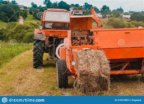 Old Tractor In The Field Forage Harvesting For The Winter Press And